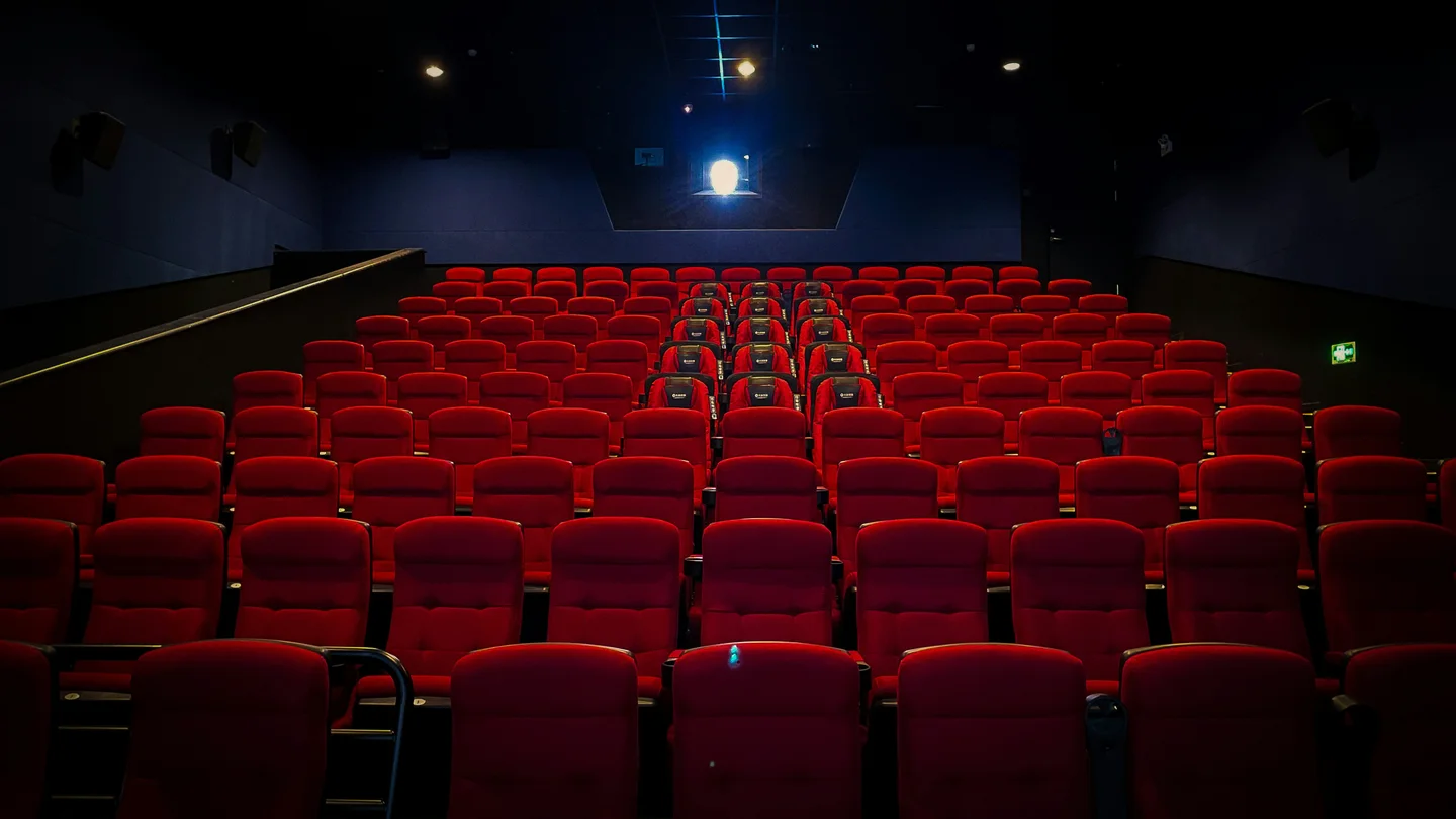 A cinema auditorium with red seats
