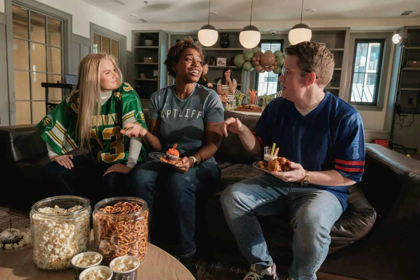Friends watching sport together on a sofa